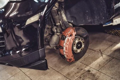 Car brake system undergoing repair and service in garage Stock Photos