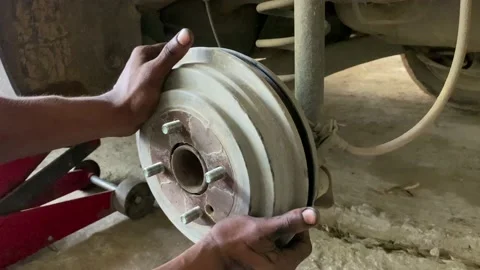 Car break drum fixing by mechanic in the garage, auto break drum fix up Video stock 159015532