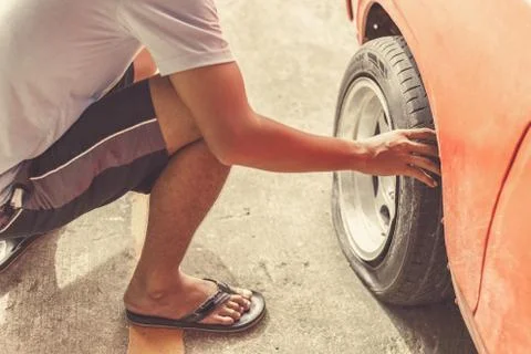 Car breakdown and wheel flat tire in the park. Stock Photos