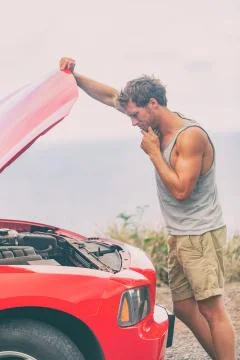 Car breakdown problem. Road trip travel young man on side of the road with Foto stock