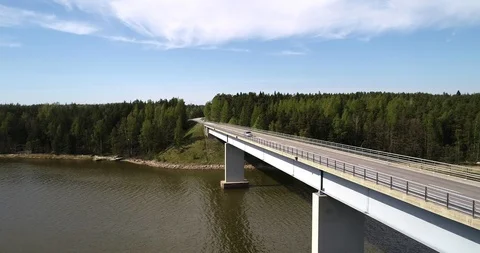 Car on a bridge, C4k aerial reverse view of a vehicle driving over a bridge,  Stock Footage 89961271
