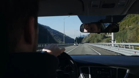 The car is on the bridge. Hands on steering wheel and dashboard of a car during Video stock 166175889