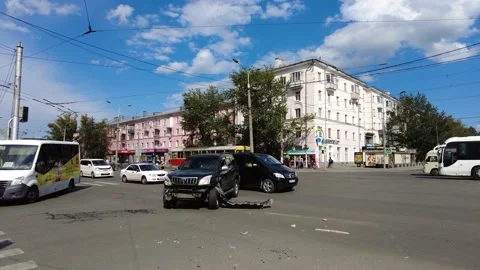 A car with a broken bumper stands in the middle of the road after a collision Stock Footage 203880353