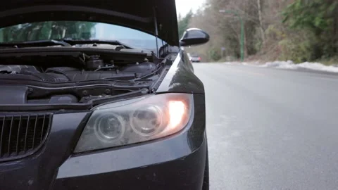 Car broken down by roadside with hazard lights and hood open. 4K 24FPS Stock Footage 230173680
