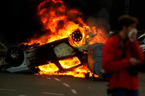 Car burning after street riots Stock Photos