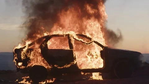 Car burning during sunset Stock Footage