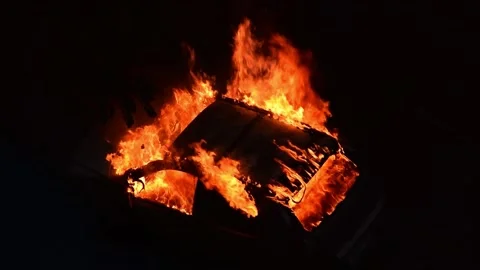 Car burning in fire explosion accident during street riot attack at night Stock Footage 138659072