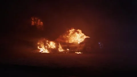 Car burning in flames after a car crash at night. Stock Footage 256232008