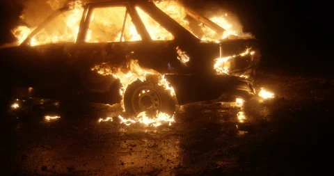Car burning at night. Slow motion. Stock Footage 130122119