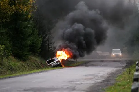 Car burning on road Stock Photos
