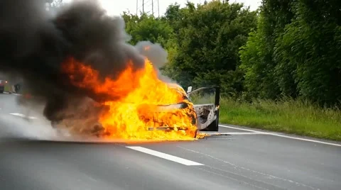 A car burns on the highway Stock Footage 65009822