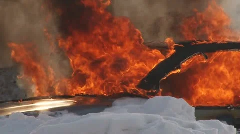 Car burns in snow Stock Footage 10817673