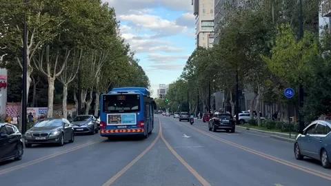 Car, bus, Wolt delivery, public transport Ilia Chavchavadze Avenue Stock Footage 326826136