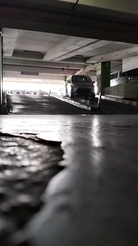 A car came down from the parking building at the walnut shop at a slow pace Stock Footage 219655566