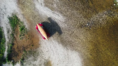 Car with canoe on the rooftop passing stream Stock Footage 276387679