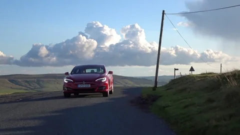 Car to car shot of a Tesla Model S at sunset Stock Footage