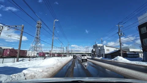 Car changes lane to avoid turning vehicle in Hakodate winter city Video stock 333069455