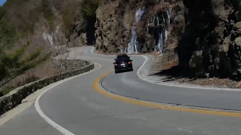 Car Chase Down Winding Road Stock Footage