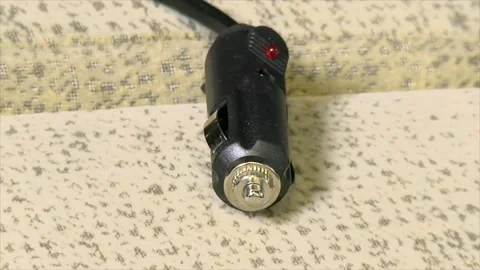 Car cigarette lighter plug connector of a handheld automobile vacuum cleaner Stock Footage 279176443