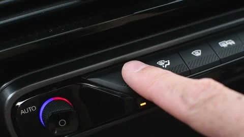 Car climate control panel with finger pressing A/C and airflow buttons, Stock Footage 310617960