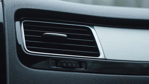 Car climate control turning on dashboard air vent with fan blowing interior air Stock-Footage 325908139