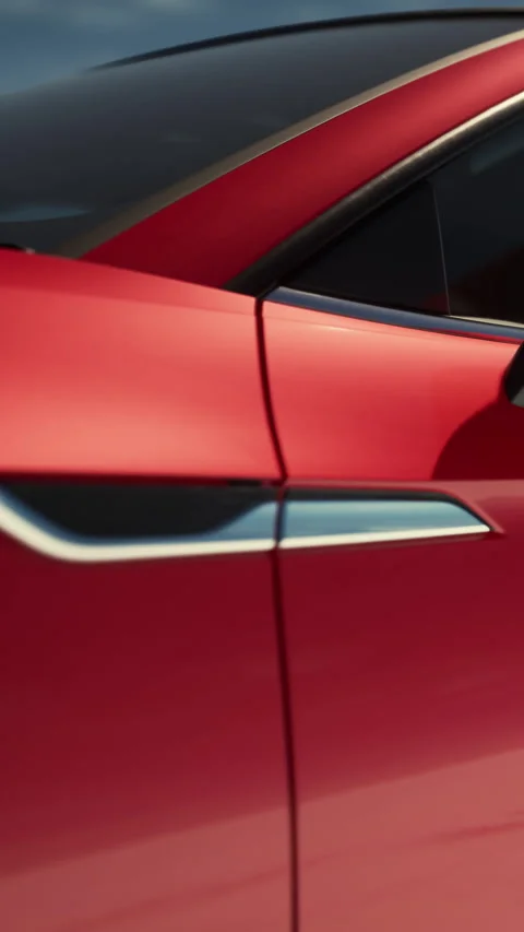 Car close up shows design and color of a red vehicle parked outdoors Vidéo 337970216