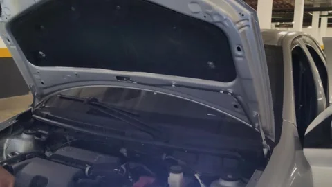 Car closing the hood showing engine for maintenance in a garage. Stock Footage 313299763