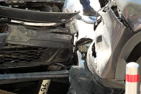 Car collision at busy intersection during daylight Stock Photos