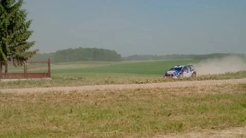 Car coming from afar in a dust cloud - rally car drifting - slow motion Stock Footage 157375201