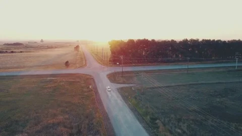 Car Coming Up to Intersection at Sunset Video stock 283943708