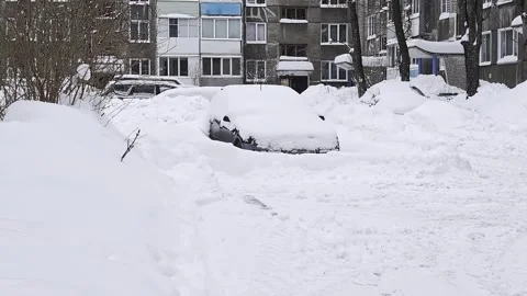 Car completely buried under thick layer of snow after heavy snowfall, parked Stock Footage 326750199