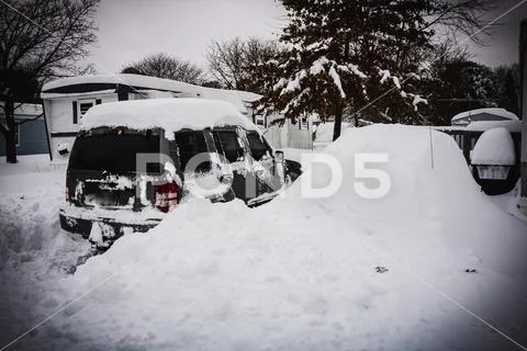 Car completely covered by a pile of snow during severe snow storm in ...