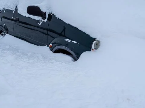 Car completely snowed in in winter. Stock Photos