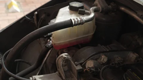 Car coolant reservoir and engine compartment detail Видео 345103335