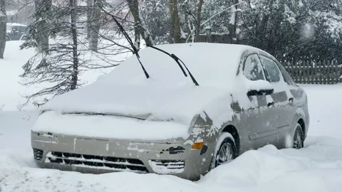 A Car is covered &amp; blocked in by snowdrift during a snowstorm. Stock Footage 145292883