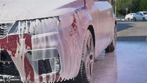 Car covered with foam. Video stock 93689885