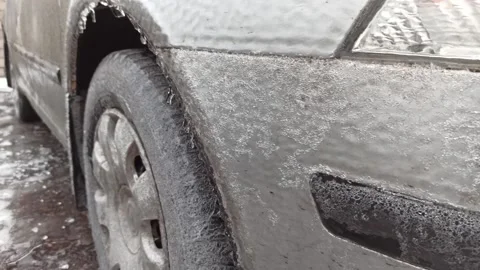 Car covered with a layer of ice in the parking lot Stock Footage 226796206