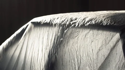 The car covered with polyethylene Vídeos de archivo 117940343