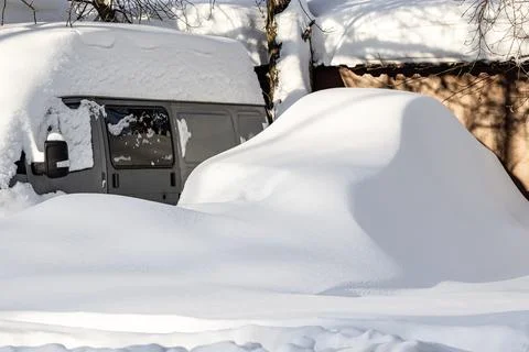 A car covered in snow after a blizzard. Stock Photos