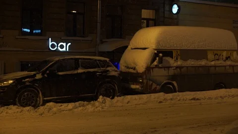 Car is covered with snow. Heavy snowfall in the city at night. Stock Footage 89181269