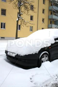 Car covered with snow in winter Stock Photos