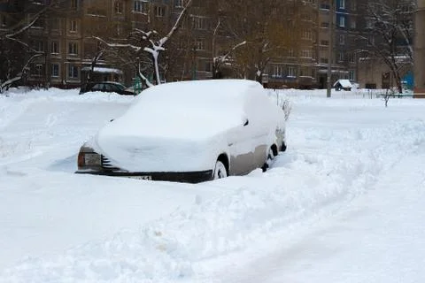 The car is covered with a thick layer of snow Stock Photos