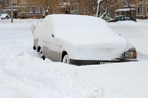 The car is covered with a thick layer of snow Stock Photos