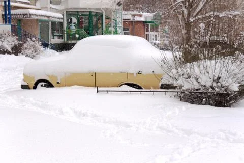 The car is covered with a thick layer of snow Photos