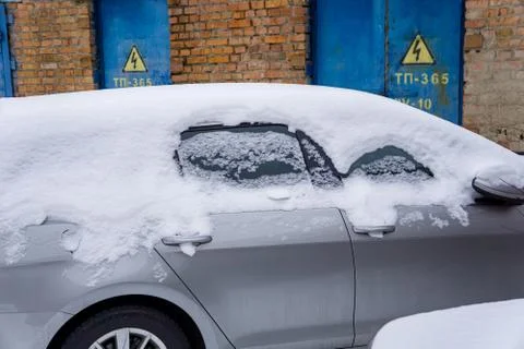 The car, covered with thick layer of snow. Negative consequence of heavy snow Stock Photos