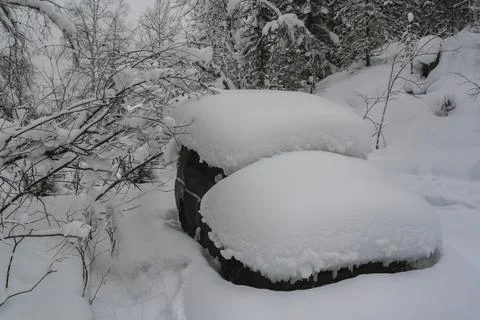 Car is covered with thick layer of snow after heavy snowfall. Stock Photos