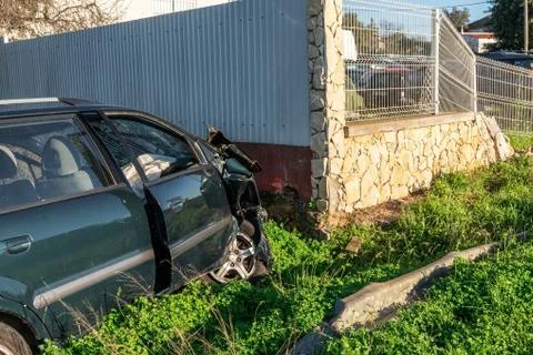 The car crashed into the wall, looking after the crash. Drunk driver. Stock Photos
