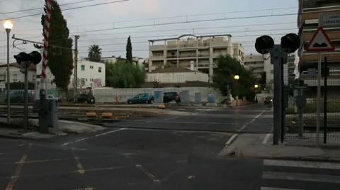 Car crosses a train level crossing and warning bells and lights. Stock Footage 8579534