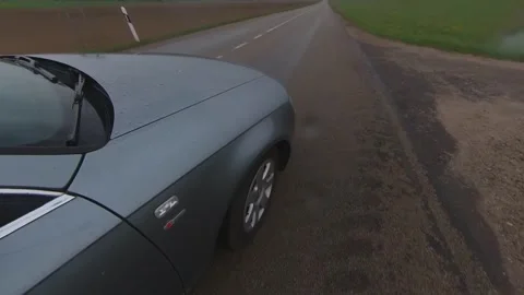 A Car Crossing an Intersection on a Rainy Day. Stock Footage 242671268