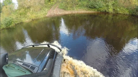 The car crossing the river in a deep place on the road. Stock Footage 68040663